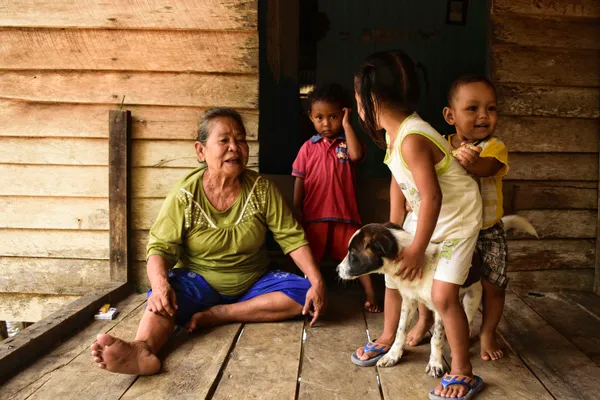 grandmother with grandchildren sitting doorway