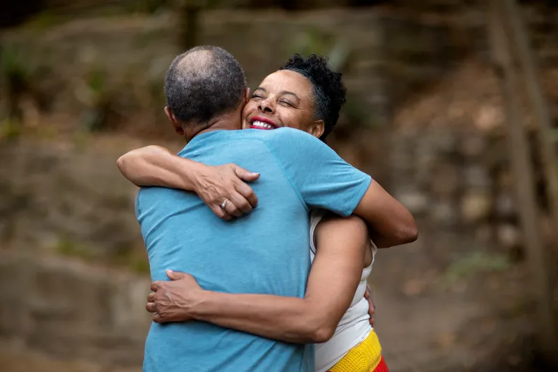 medium shot senior people hugging outside